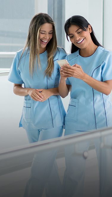 Two Women in Healthcare Looking at Phone