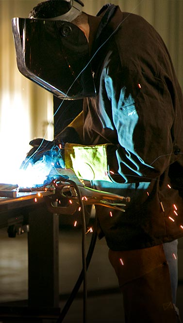 Man working on project with sparks flying
