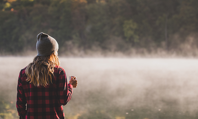 woman outdoors w coffee | Creativity during COVID