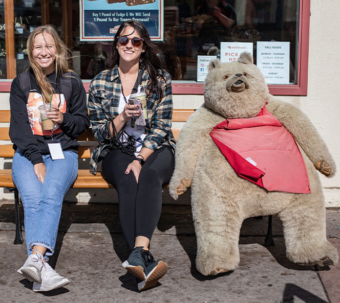 on a bench with a stuffed bear