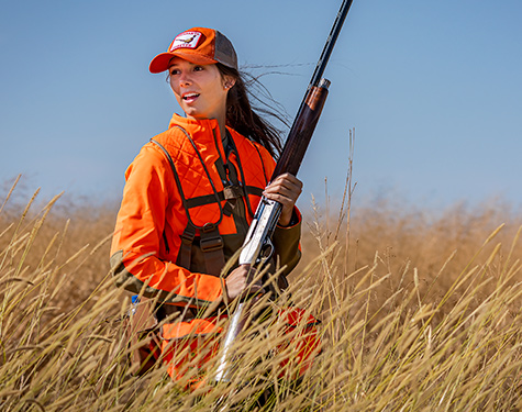 woman with a gun in a field