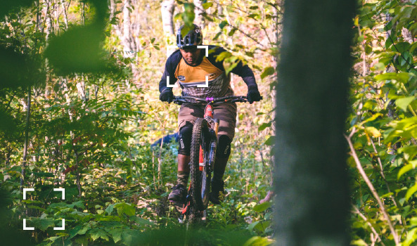 man biking through the trees