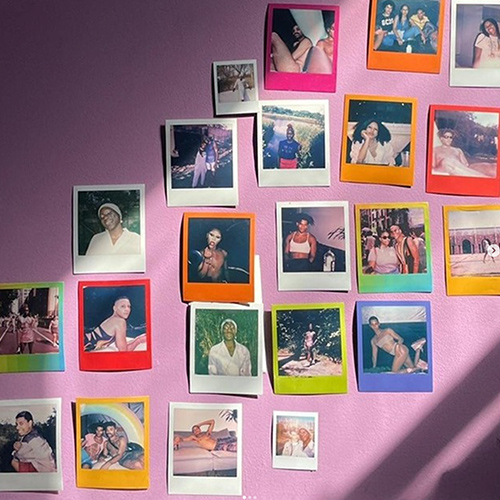 Colorful Polaroid pictures on a pink wall