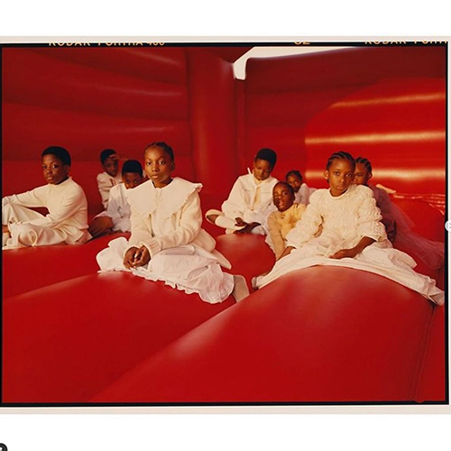 children wearing white in a red room