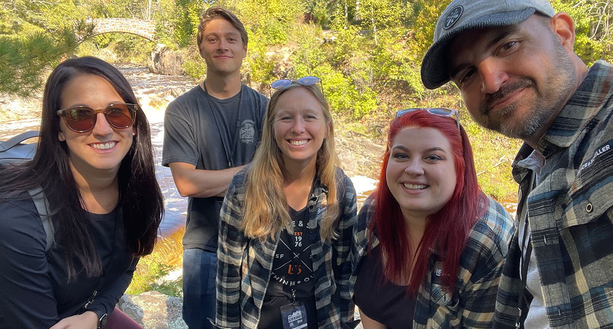 group selfie by a creek