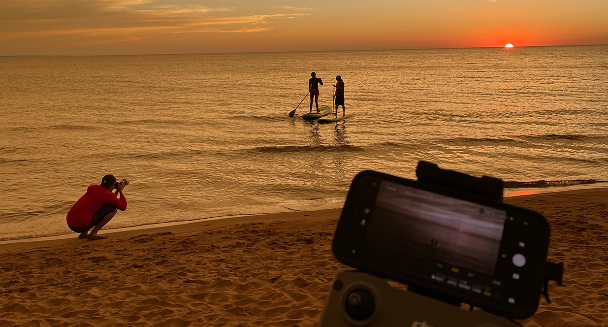 people paddleboarding off the shore