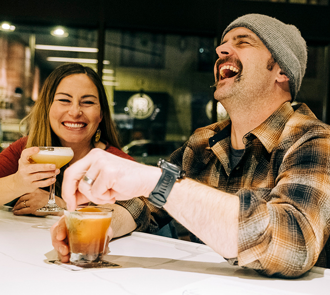 man and woman drinking and laughing