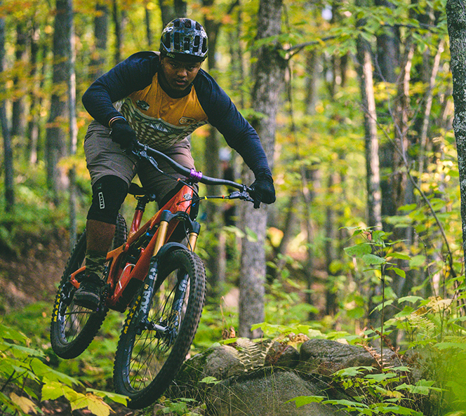 man biking through the trees