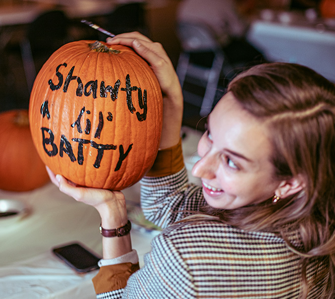woman holding a pumpkin