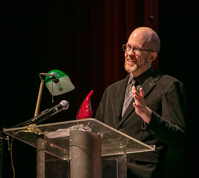 Wade Thurman speaking at a podium