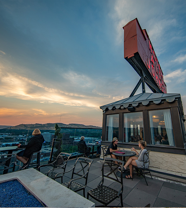 people sitting at a rooftop bar