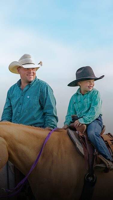 Father and child riding horses