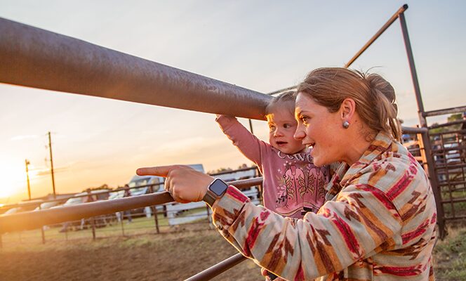 Mother pointing at something with her child