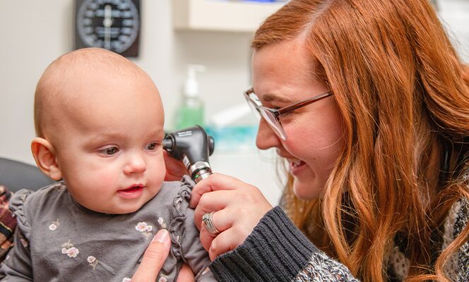 Baby getting a check-up from a doctor