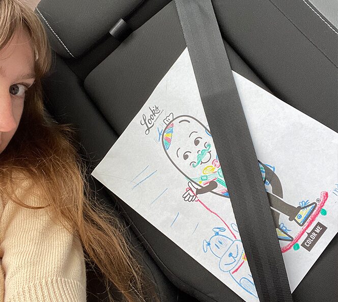 girl in car with drawing