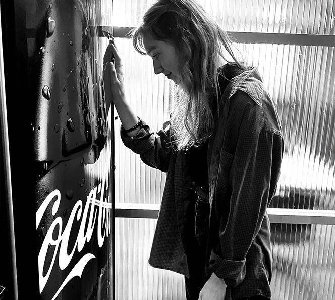 girl standing next to vending machine