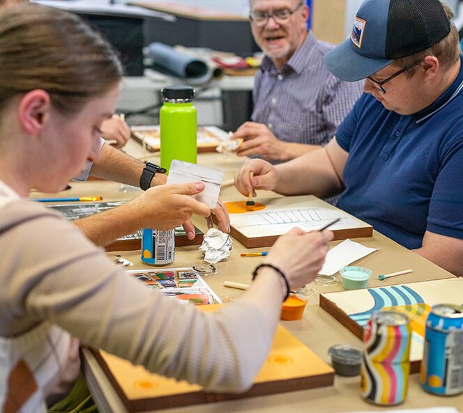 group sitting painting